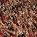 Suporter Timnas Indonesia selalu menyanyikan lagu nasional setiap pertandingan. (AFP/YASUYOSHI CHIBA)